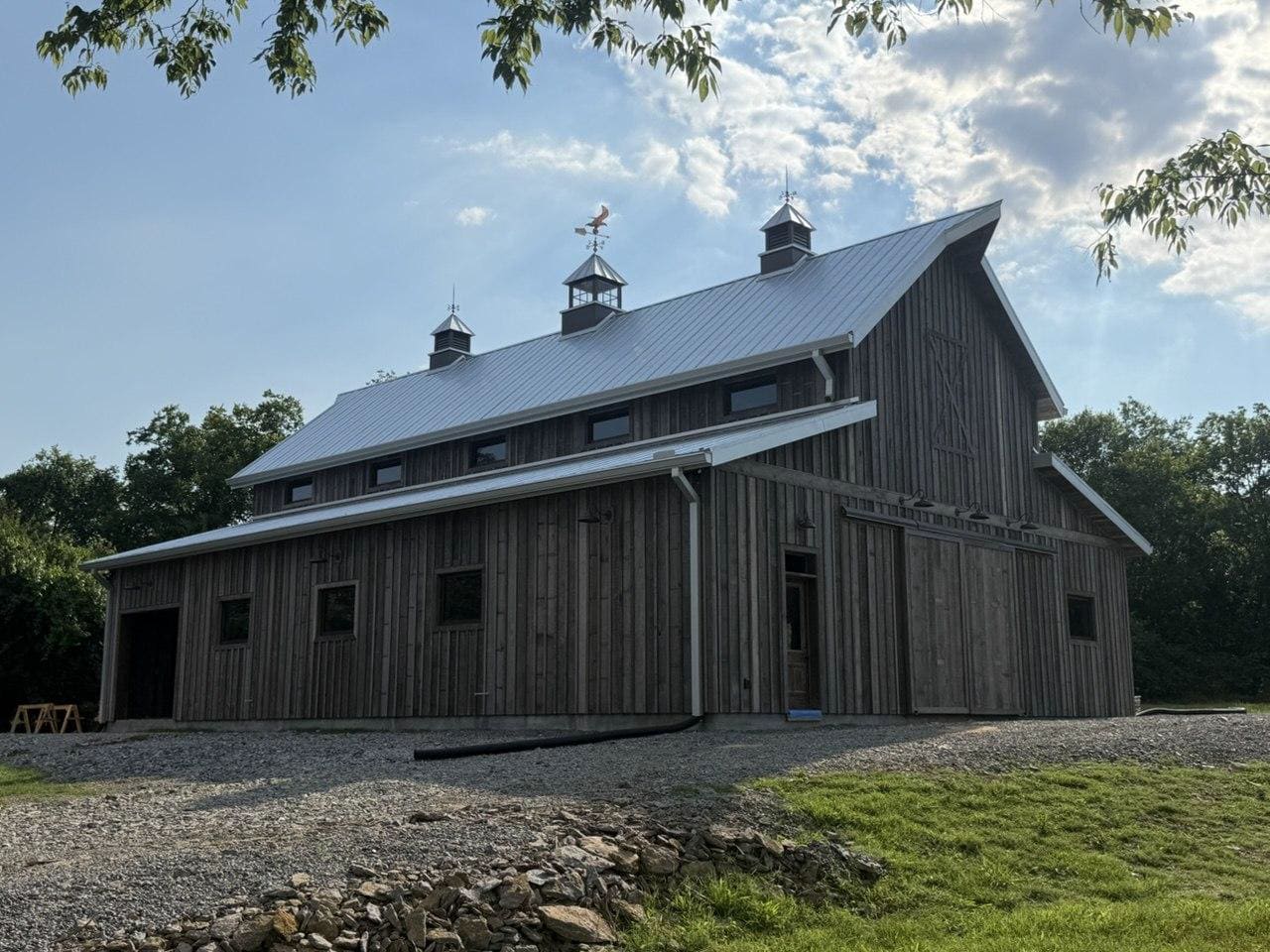 Same large barn after multiple cupolas were installed